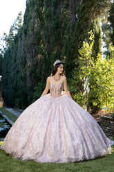 "Quinceañera dress in blush rose gold. Elegant ball gown for 15th birthday. Features lace details and sequins."