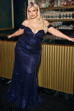 Woman in a sparkly blue dress standing in front of a bar.www.snkdress.com Plus size off-shoulder glitter ball gown by Ladivine