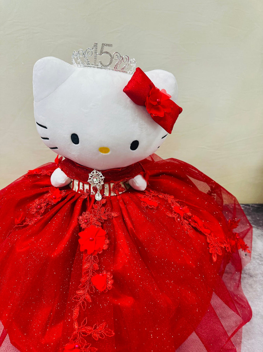 red Hello Kitty plush doll for quinceañera party, accessible for visually impaired.