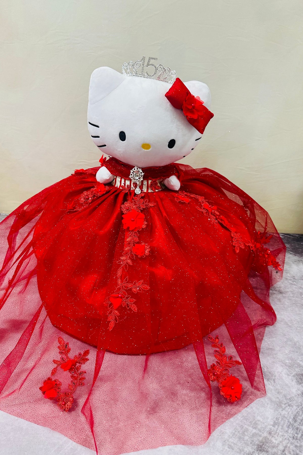red Hello Kitty plush doll for quinceañera party, accessible for visually impaired.